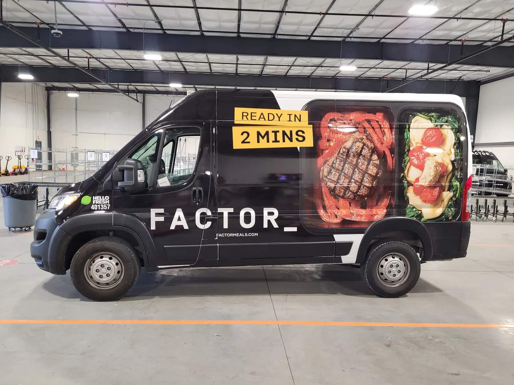 A Factor Meals delivery van wrapped by That’s A Wrap Nashville, parked inside the shop.